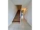 Clean entryway with tile flooring and a staircase leading upstairs at 5150 Picadilly Circus Ct # 7, Orlando, FL 32839