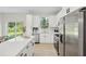 Modern kitchen with white cabinets, stainless steel appliances, and quartz countertops at 1620 9Th Ave, Deland, FL 32724