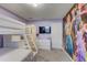 Charming bedroom with a bunk bed and a whimsical wall mural at 1842 Tropical Palms Cir, Kissimmee, FL 34747