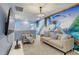 Cozy game room featuring a comfortable couch and a large mural at 1842 Tropical Palms Cir, Kissimmee, FL 34747