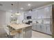 Modern kitchen with gray cabinets, stainless steel appliances, and an island at 1842 Tropical Palms Cir, Kissimmee, FL 34747