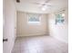 Spacious bedroom with tile flooring and two windows at 1721 Bellgrove St, Lakeland, FL 33805