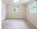 Spacious bedroom with tile flooring and two windows at 1721 Bellgrove St, Lakeland, FL 33805
