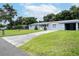 Gray house with a carport and well-maintained lawn at 1721 Bellgrove St, Lakeland, FL 33805
