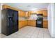 Simple kitchen with light wood cabinets and black appliances at 1721 Bellgrove St, Lakeland, FL 33805