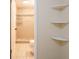 Clean bathroom with tile shower and additional shelving at 1721 Bellgrove St, Lakeland, FL 33805