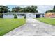 Newly painted light blue house with a spacious yard and driveway at 1721 Bellgrove St, Lakeland, FL 33805