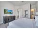 King-size bed, dresser, and large TV in this bedroom at 7770 Sandy Ridge Dr # 201, Reunion, FL 34747