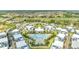 Aerial view showing modern townhome community with pool and lush landscaping at 7770 Sandy Ridge Dr # 201, Reunion, FL 34747