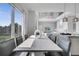 Sunlit dining area with marble table and modern chairs at 7770 Sandy Ridge Dr # 201, Reunion, FL 34747
