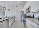 Modern kitchen with stainless steel appliances and gray countertops at 7770 Sandy Ridge Dr # 201, Reunion, FL 34747