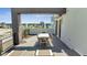 Spacious rooftop balcony with outdoor dining furniture and lounge chairs at 7770 Sandy Ridge Dr # 201, Reunion, FL 34747