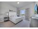 King-size bed and large windows in this bright bedroom at 7770 Sandy Ridge Dr # 201, Reunion, FL 34747