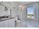 Modern bathroom boasts a large shower, updated vanity, and plenty of natural light at 7770 Sandy Ridge Dr # 201, Reunion, FL 34747