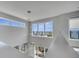 High-ceilinged loft with expansive windows and modern light fixture at 7770 Sandy Ridge Dr # 201, Reunion, FL 34747