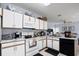 Well-equipped kitchen featuring white cabinets, modern appliances, and ample counter space at 526 Maricopa Dr, Kissimmee, FL 34758