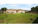 Large backyard with grassy lawn and a wooden deck at 526 Maricopa Dr, Kissimmee, FL 34758