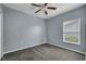 Simple bedroom with window, ceiling fan, and carpet at 526 Maricopa Dr, Kissimmee, FL 34758