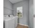 Convenient laundry room with washer, dryer, and overhead shelving at 526 Maricopa Dr, Kissimmee, FL 34758