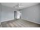 Cozy bedroom with grey walls, carpet flooring, and access to a bathroom at 526 Maricopa Dr, Kissimmee, FL 34758