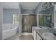 Modern bathroom with double vanity, garden tub, and glass shower at 526 Maricopa Dr, Kissimmee, FL 34758