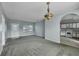 Open living area with neutral carpeting and kitchen views at 526 Maricopa Dr, Kissimmee, FL 34758