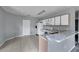 Functional kitchen with white cabinets, appliances, and breakfast bar at 526 Maricopa Dr, Kissimmee, FL 34758