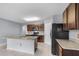 Modern kitchen with dark brown cabinets and a large island at 816 William Way, Haines City, FL 33844