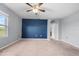 Large bedroom featuring a blue accent wall and ceiling fan at 816 William Way, Haines City, FL 33844