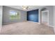 Spacious bedroom with blue accent wall and ceiling fan at 816 William Way, Haines City, FL 33844