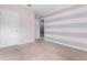 Bedroom with grey and pink striped wall at 816 William Way, Haines City, FL 33844