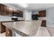 Modern kitchen with dark brown cabinets, granite counters, and island at 816 William Way, Haines City, FL 33844