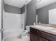 Bathroom with tub, toilet and vanity with dark brown cabinets at 816 William Way, Haines City, FL 33844