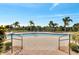 Resort-style community pool with ample deck space and surrounding palm trees at 1808 Coriander Dr, Kissimmee, FL 34759