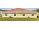 Rear view of a single-story house featuring a tile roof and three windows at 1808 Coriander Dr, Kissimmee, FL 34759