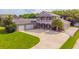 Two-story house with a three-car garage and manicured lawn at 1380 E Lake Shore Blvd, Kissimmee, FL 34744