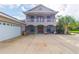 Two-story house with a large driveway and a three-car garage at 1380 E Lake Shore Blvd, Kissimmee, FL 34744