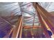 Image shows unfinished attic space with exposed wooden beams and insulation at 1380 E Lake Shore Blvd, Kissimmee, FL 34744