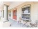 Front porch with red double doors and small sitting area at 1380 E Lake Shore Blvd, Kissimmee, FL 34744