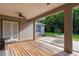 Covered patio with wooden flooring, french doors, and backyard view at 1380 E Lake Shore Blvd, Kissimmee, FL 34744