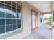 Balcony with red door and large window overlooking neighborhood at 1380 E Lake Shore Blvd, Kissimmee, FL 34744