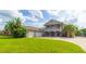 Two-story home with three-car garage and lush landscaping at 1380 E Lake Shore Blvd, Kissimmee, FL 34744