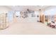 Large bonus room with carpeted floor, ceiling fan, and ample natural light at 1380 E Lake Shore Blvd, Kissimmee, FL 34744