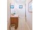 Clean bathroom with wood vanity, tiled floors, and a walk-in shower at 1380 E Lake Shore Blvd, Kissimmee, FL 34744