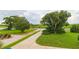Landscaped front yard with a long driveway leading to the house at 1380 E Lake Shore Blvd, Kissimmee, FL 34744