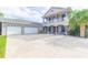 Two-story house with double garage, covered porch, and well-maintained landscaping at 1380 E Lake Shore Blvd, Kissimmee, FL 34744