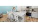 Clean and modern kitchen with white cabinets, quartz countertops, and stainless steel appliances at 2980 On The Rocks Pt, Kissimmee, FL 34747