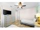 Bedroom with twin bed, dresser, and ensuite bath at 2980 On The Rocks Pt, Kissimmee, FL 34747