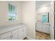 Clean bathroom with white vanity and light blue walls at 2980 On The Rocks Pt, Kissimmee, FL 34747