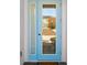 Modern light blue front door with glass panels and a welcoming mat at 2980 On The Rocks Pt, Kissimmee, FL 34747